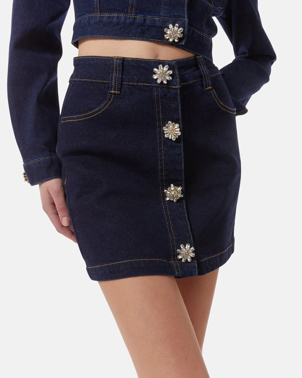 Dark denim miniskirt with jewel buttons